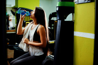 Midsection of woman drinking glass