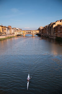 Bridge over river with city in background