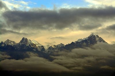 Scenic view of mountains against cloudy sky