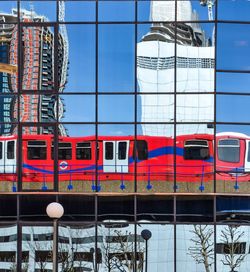 London train reflection in glass building