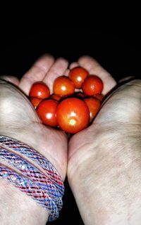 Close-up of hand holding tomatoes