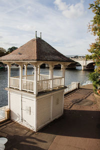 Built structure by lake against sky