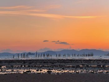 Scenic view of beach against sky during sunset