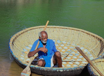 High angle view of man sitting on boat