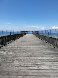 Pier on sea against clear sky