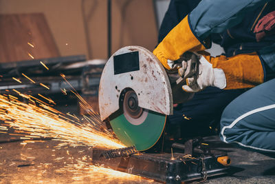 Low angle view of man working on metal