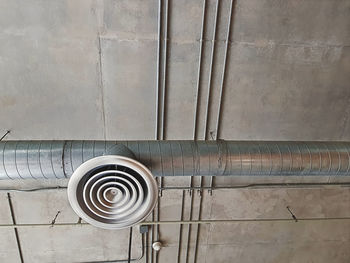 Low angle view of pipes on wall