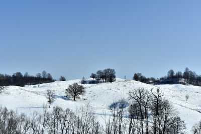 Scenic view of snowcapped mountains against clear blue sky