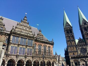 Low angle view of historical building against blue sky