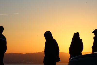 Silhouette of people at sunset