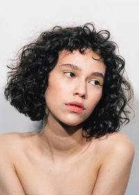 Portrait of beautiful young woman over white background