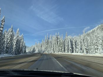 Road against sky seen through car windshield