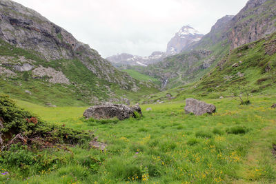 Scenic view of land and mountains against sky