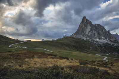 Scenic view of land and mountains against sky