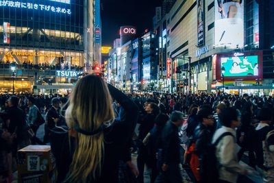 People walking on city street at night