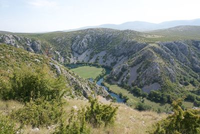 High angle view of valley and mountains against sky