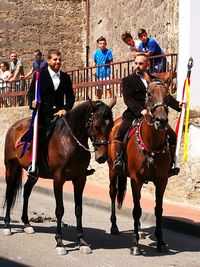 Man with horse in background