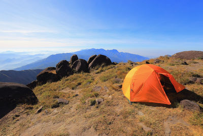 Scenic view of tent on mountain against sky