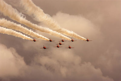 Low angle view of airshow in sky