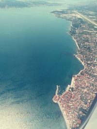 Aerial view of sea and cityscape