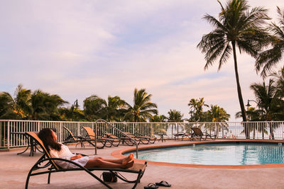 Swimming pool at beach against sky