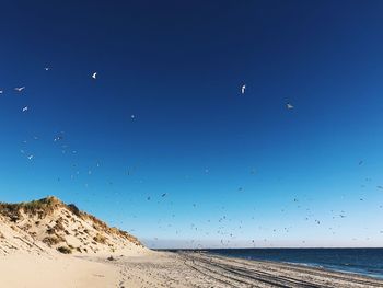 Scenic view of sea against clear blue sky