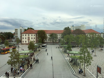 Buildings in city against cloudy sky