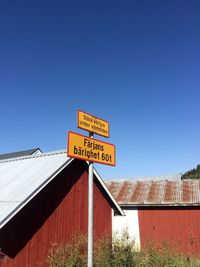 Low angle view of information sign against clear sky