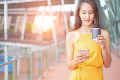 Young woman using mobile phone outdoors