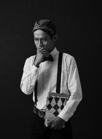 Man against black background