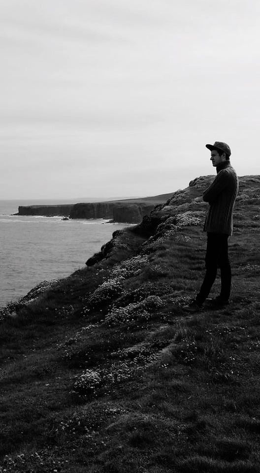 full length, water, lifestyles, sea, leisure activity, rear view, standing, casual clothing, sky, beach, tranquility, tranquil scene, horizon over water, men, nature, shore, scenics, beauty in nature