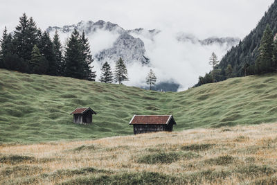 Scenic view of field and mountains against sky