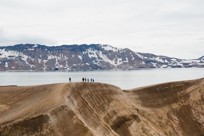 Scenic view of sea and mountains against sky