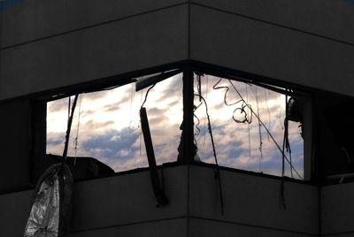 Low angle view of building against cloudy sky