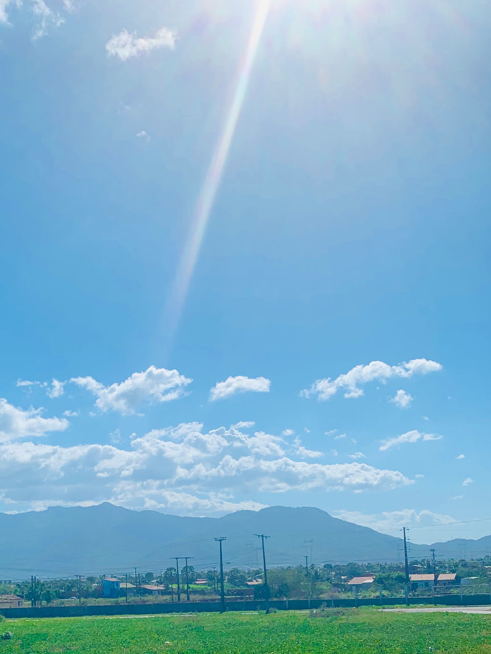 RAINBOW OVER LANDSCAPE AGAINST SKY