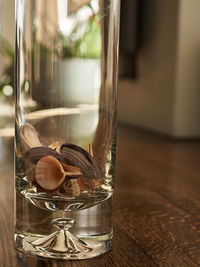 Close-up of glass vase  on wooden floor