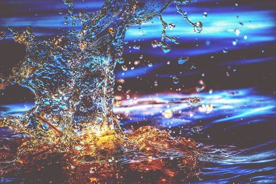 Close-up of water drops on blue surface