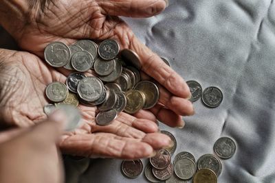 Cropped hand of man holding coins