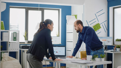 Business colleague having discussion at office