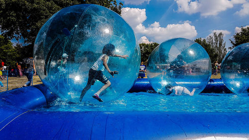 Digital composite image of people in swimming pool