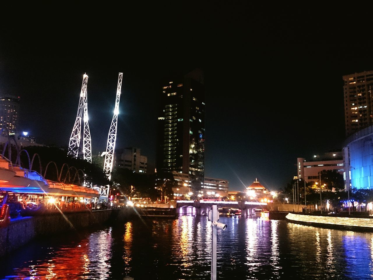 ILLUMINATED BUILDINGS AT WATERFRONT