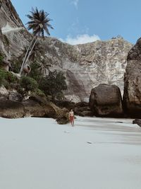 Man on rock at beach