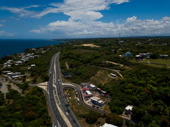 High angle view of cityscape by sea against sky