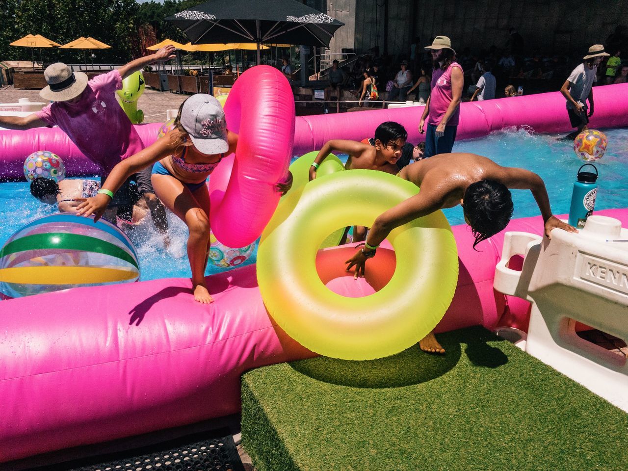 multi colored, swimming pool, enjoyment, pool party, inflatable, celebration, party - social event, friendship, outdoors, people, cheerful, cultures, water, adult, adults only, day, water park