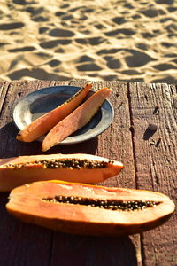 Eating fresh cut papaya on the beach