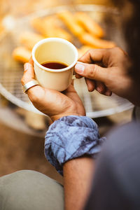 Close-up of woman holding coffee cup