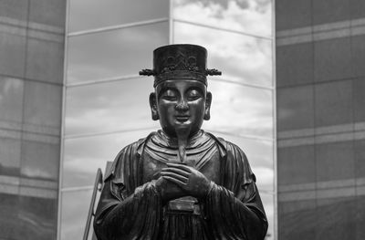 Low angle view of statue against building