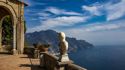 Sculpture by sea against sky