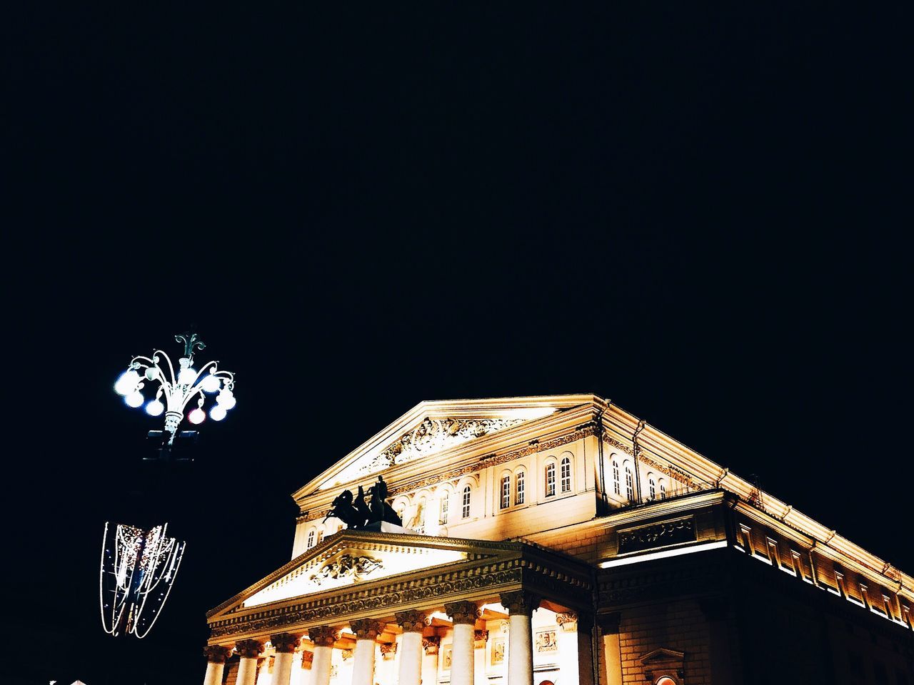 architecture, built structure, building exterior, low angle view, night, clear sky, copy space, illuminated, religion, place of worship, history, high section, sky, spirituality, outdoors, no people, temple - building, house, building, roof