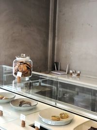 Close-up of cookies jar on glass table